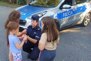 policjantka pokazująca uczestnikom zajęć kajdanki