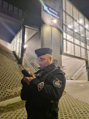 policjant i funkcjonariusze Straży Ochrony Kolei na terenie dworca kolejowego