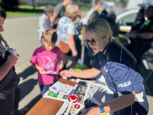 Policjantka Ruchu Drogowego przy policyjnym stoisku (Średni)