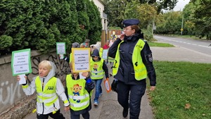 06 Policjantka zabezpiecza przemarsz dzieci z transparentami