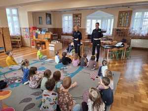 funkcjonariuszka pokazujaca czapke policyjną dzieciom