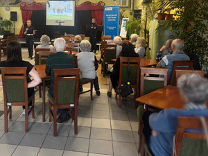 seniorzy oglądają przygotowaną przez policjantów prezentację multimedialną