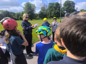 policjantka przekazuje uczniom instrukcje przed egzaminem praktycznym na kartę rowerową