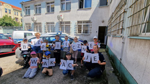wspólne zdjęcie policjantki z dziećmi przy radiowozie