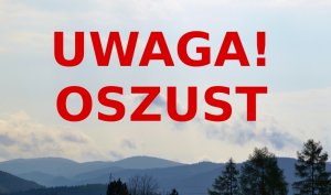 Czerwony napis Uwaga oszust, w tle góry