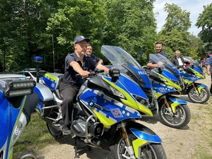 Podopieczny siedzący na policyjnym motocyklu.